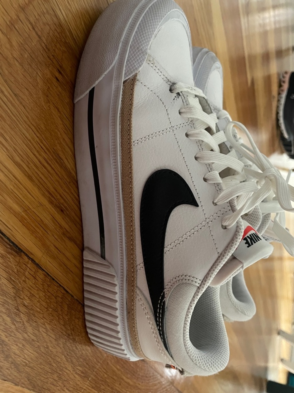 Nike White Low-Top Sneakers with Black Swoosh and Tan Accent